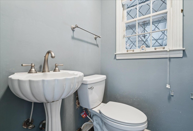 Pedestal sink with sculpted basin and dual-handle faucet