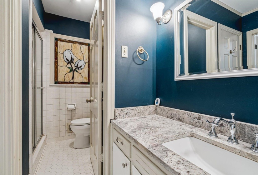 Bathroom featuring a vanity with a light-toned countertop and an undermount sink
