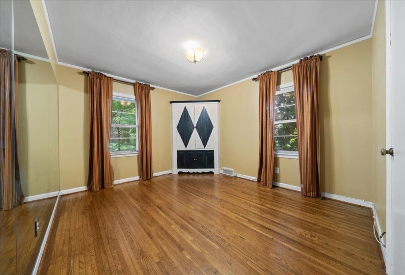 bedroom featuring crown molding and wood finished floors