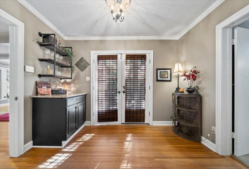 light stone counters, light wood-style flooring, and open shelves