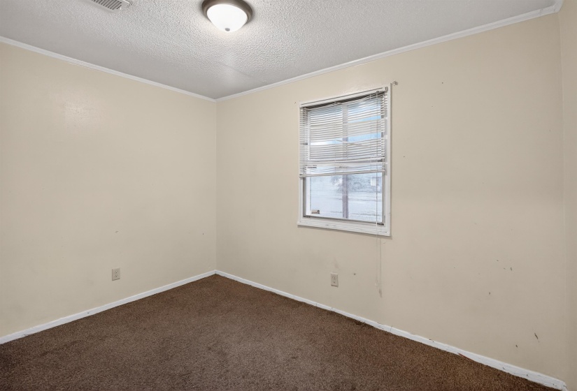 Neutral-toned walls complement the brown carpeted flooring