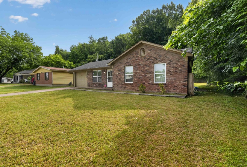 Brick exterior featuring multiple windows and an attached garage