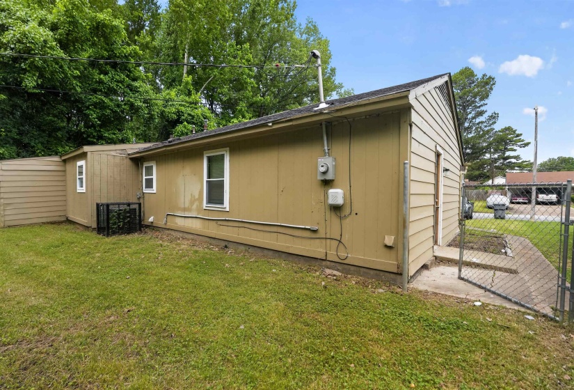 Exterior siding structure with multiple windows and a utility meter