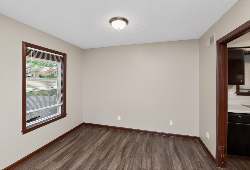 Neutral wall tones paired with dark wood-finish flooring
