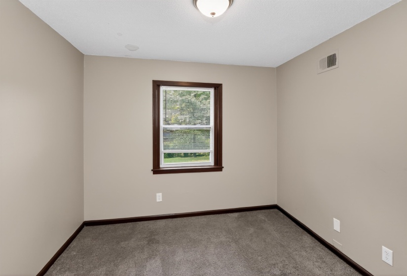 Neutral-toned walls complement the dark wood-finish trim throughout this room