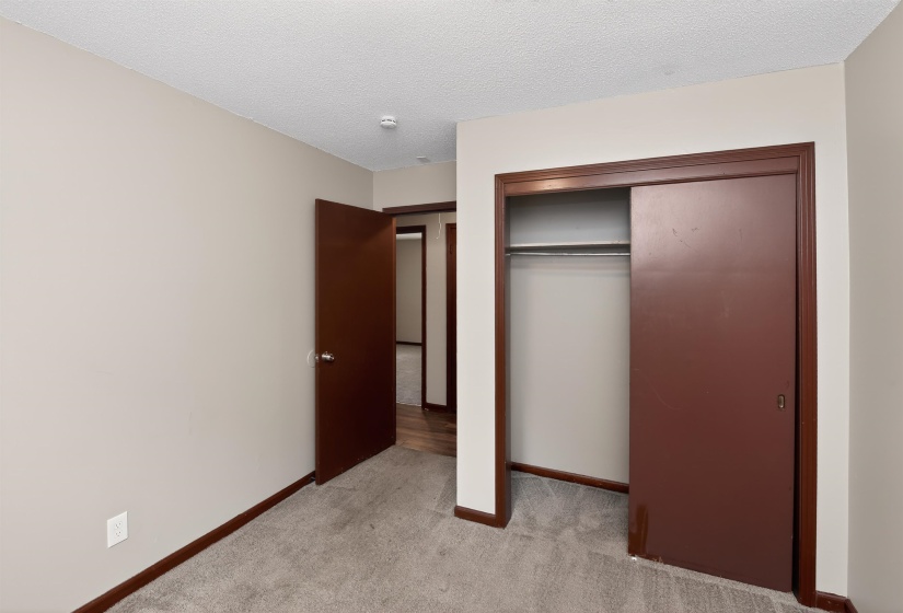 Neutral-toned walls complement the gray carpeting