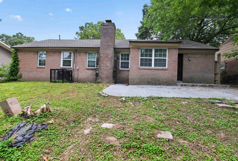 Brick exterior with a shingle roof and multiple windows