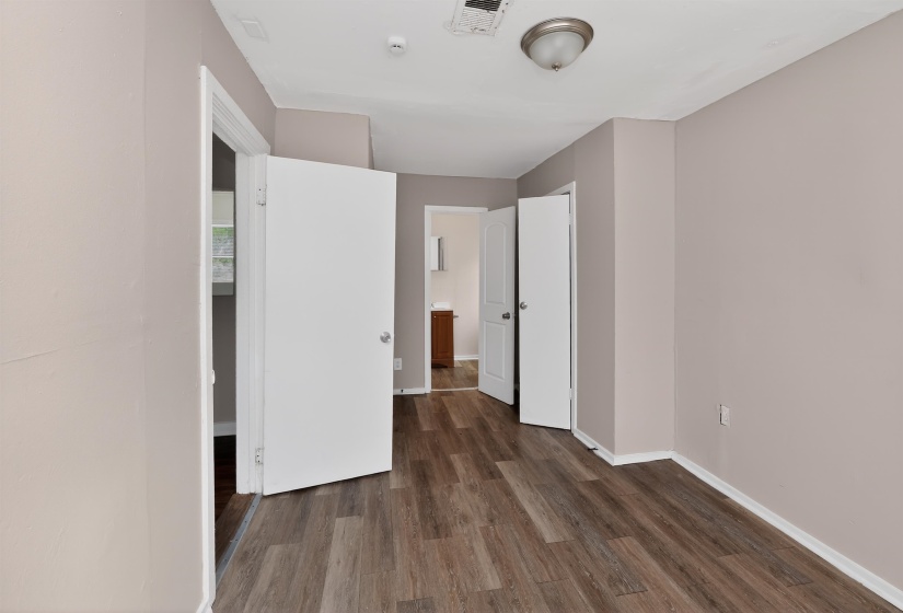 Interior room with wood-finish flooring and neutral wall tones