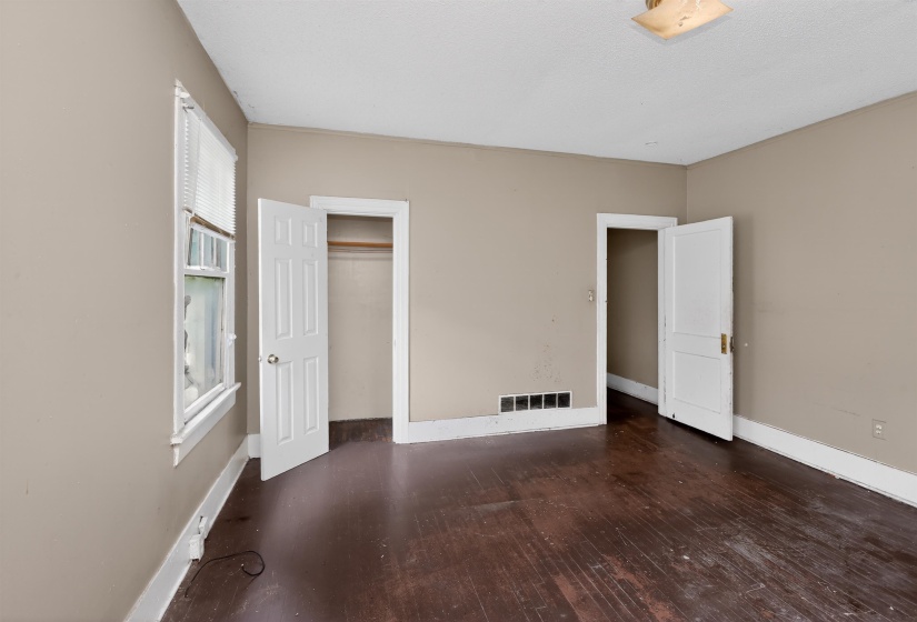 Room featuring dark wood-finish flooring and neutral-toned walls