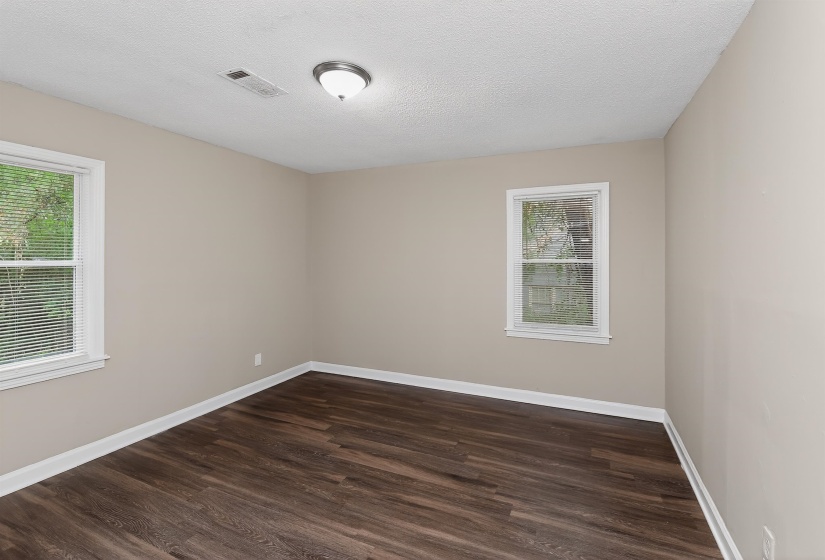 Neutral-toned walls complement wood-finish flooring in this room