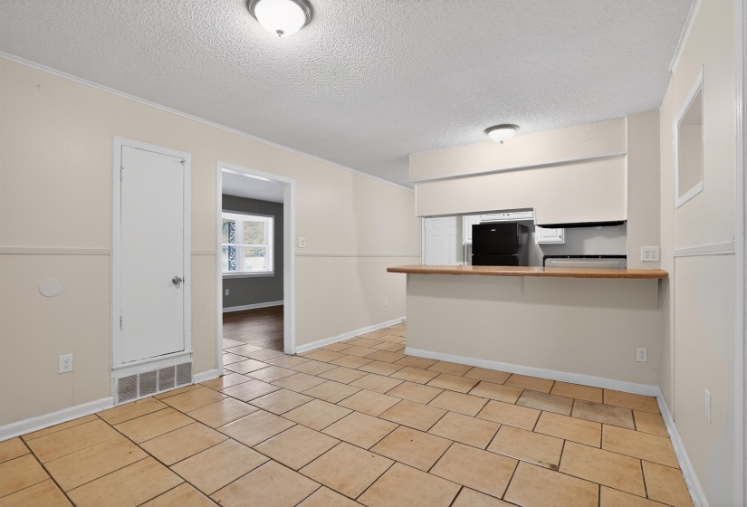 Neutral-toned tile flooring extends through this open concept space