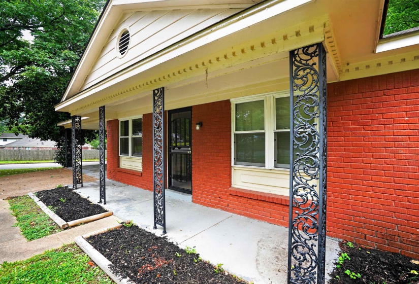 Red brick exterior featuring an inviting covered porch