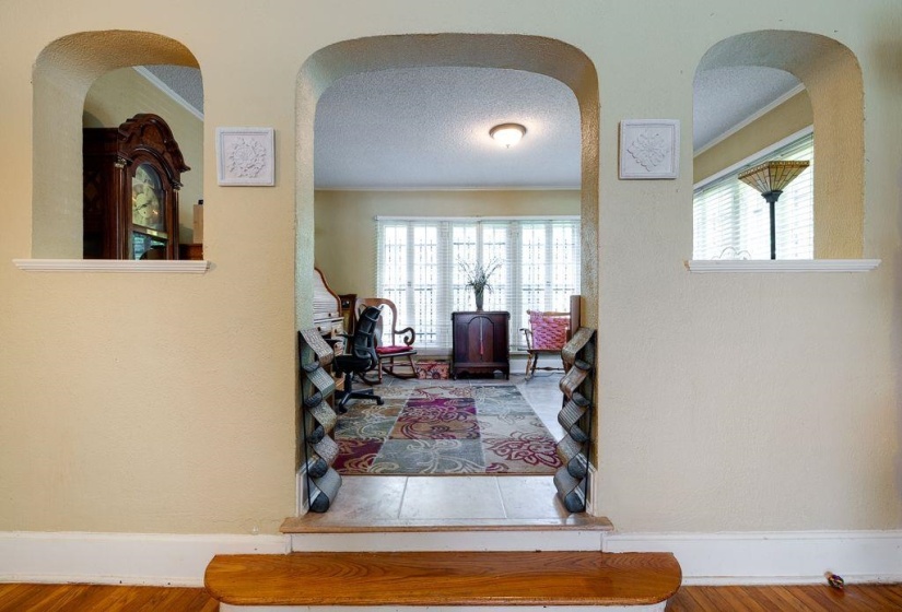Arched doorways with integrated shelving define the entryway