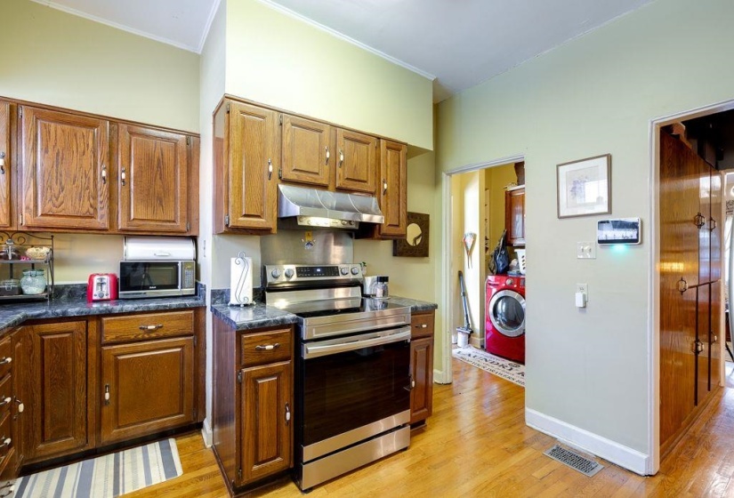 Kitchen featuring wood cabinetry, stone-finish countertops, and stainless steel appliances