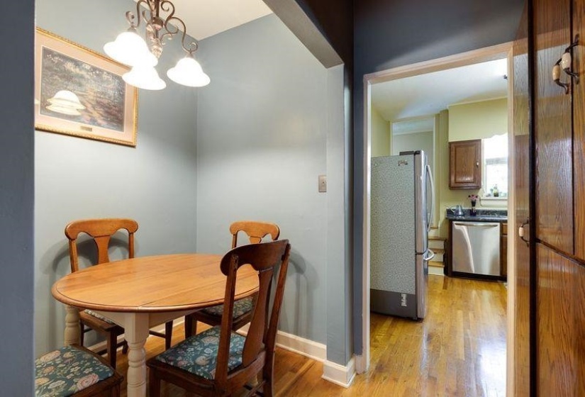 Dining area featuring a decorative ceiling light fixture and wood-finish flooring