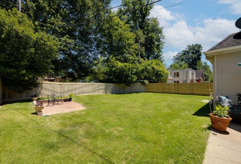 Expansive lawn with a brick paver patio