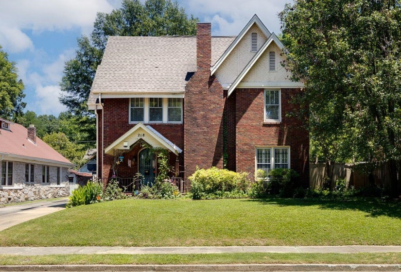 Brick exterior with white trim and a gabled roofline