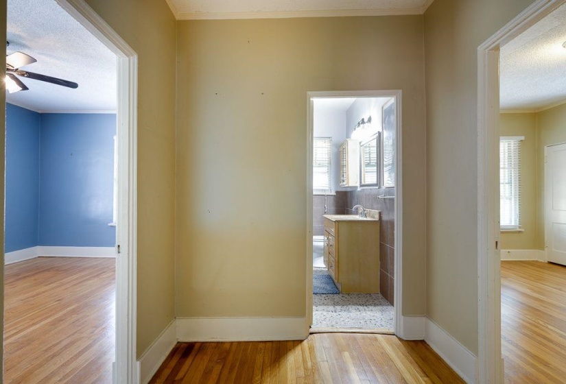 Hallway with wood-finish flooring offering access to multiple rooms