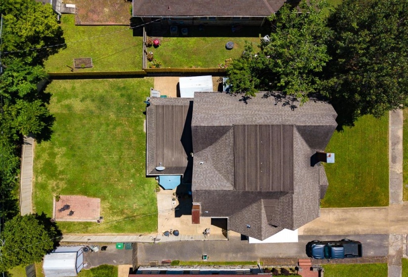 Overhead view showcasing a large residential property with a multi-gabled shingled roof