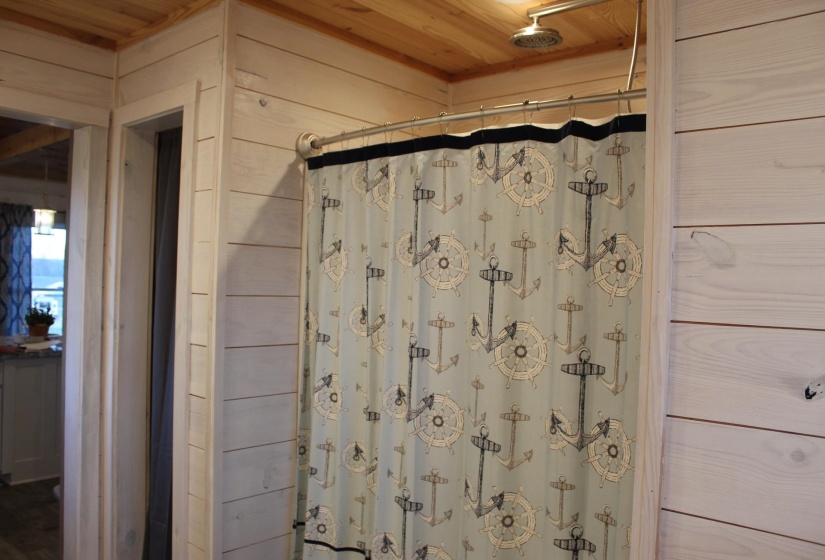 Full bathroom with wood ceiling and curtained shower