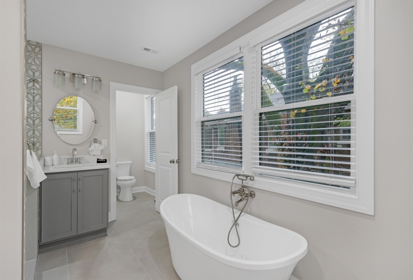 Bathroom featuring tile patterned floors, a bathtub, vanity, and toilet