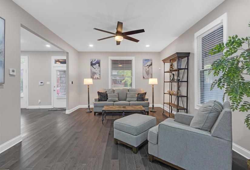 Living room featuring ceiling fan and dark hardwood / wood-style flooring