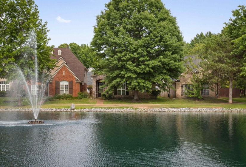 Brick and stone exterior residence featuring a prominent gable roofline and dormer windows