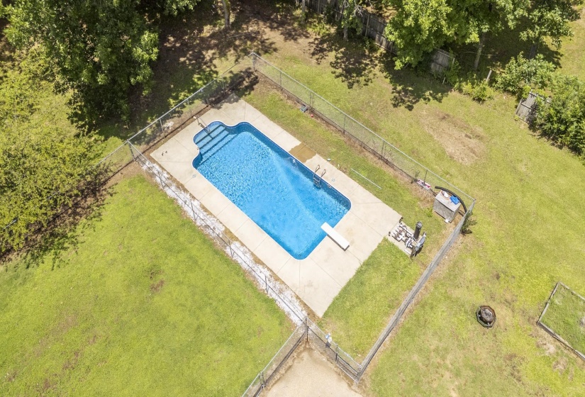 In-ground swimming pool with concrete surround