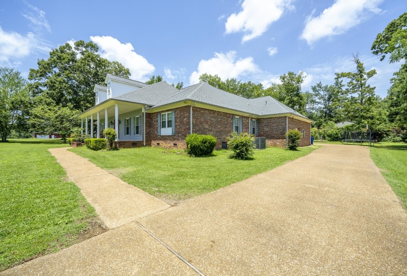 Brick exterior with a covered front porch featuring white columns