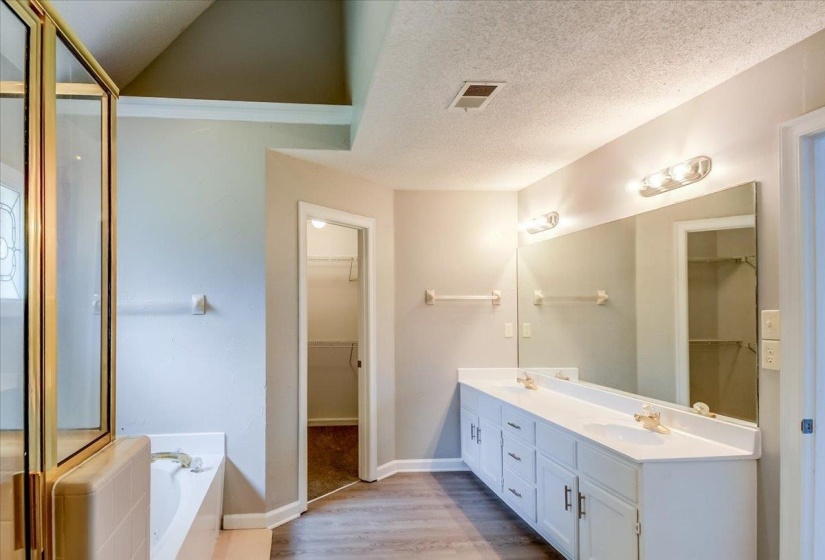 Bathroom featuring a double vanity with ample counter space, full-width mirror, and two light fixtures