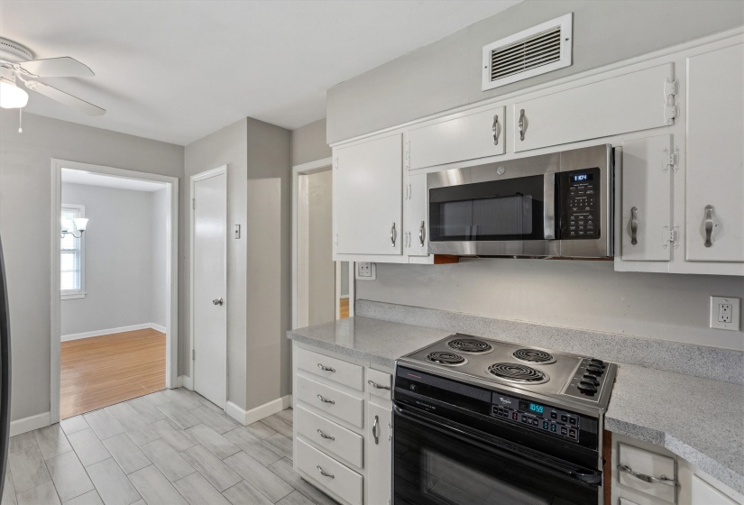 Kitchen featuring white cabinetry, light-toned countertops, and light gray wall paint