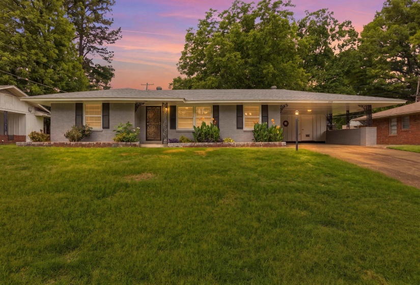 Ranch-style residence featuring a gray painted brick exterior and a covered carport
