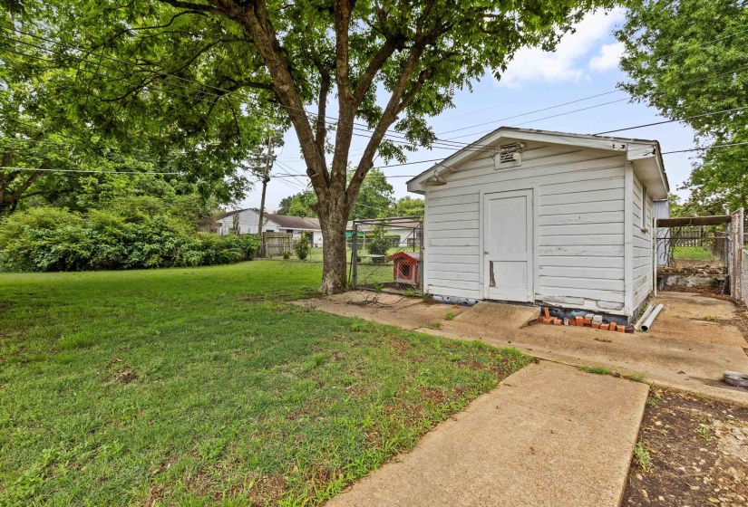 Detached storage shed with horizontal siding, a single entry door, and a gabled roofline