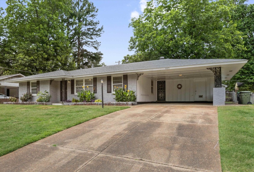 Ranch-style residence featuring a carport, brick exterior, and a concrete driveway