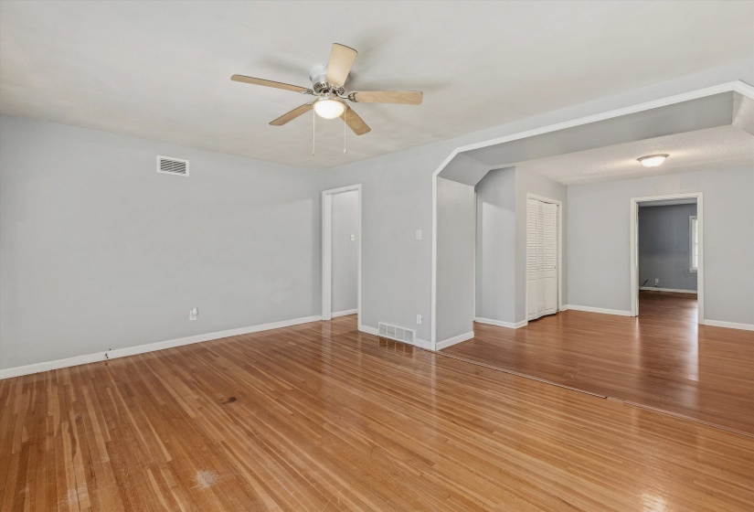 Hardwood flooring throughout, complemented by light gray wall paint and white trim
