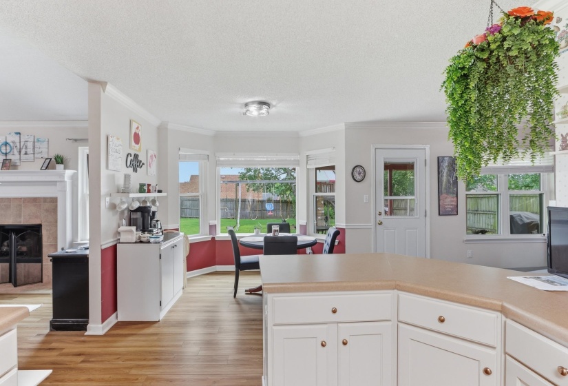 Kitchen with light wood-finish flooring, white cabinetry, and a neutral countertop