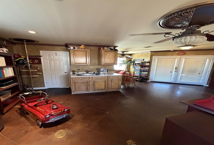 Kitchenette with wood cabinetry and a neutral countertop inside of guest house