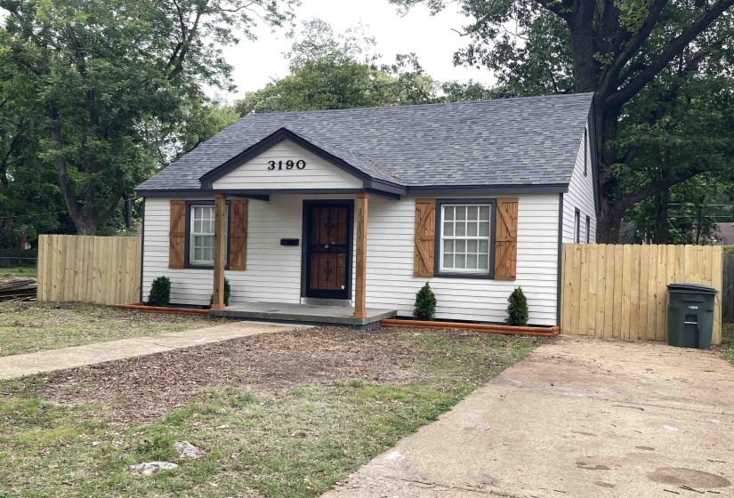 Charming exterior with white siding, dark trim, and a gray shingle roof