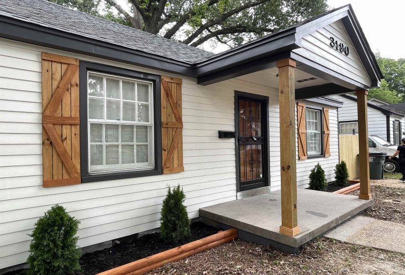 White siding exterior with a dark trim accent