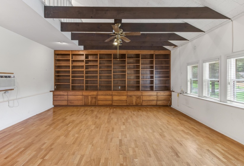 A stunning sunken den, thoughtfully and professionally converted from the original garage, is filled with character and architectural interest with it's beamed ceiling, abundant natural light and gorgeous hardwood floors!