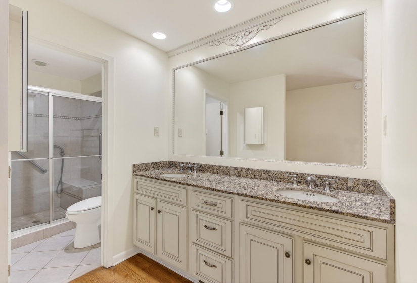 The clean and comfortable design in the primary bathroom includes a raised double vanity with granite top - providing ample space for daily routines.