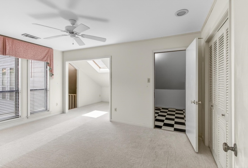The largest of the guest bedrooms, this one offers an office nook and a huge walk-in closet, in addition to the two double closets!  The entry to the left is a breezeway that overlooks the incredible den!