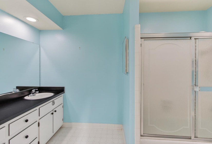 The guest bathroom is great in size, and also features a raised double vanity, and a tub/shower enclosure with tile flooring.