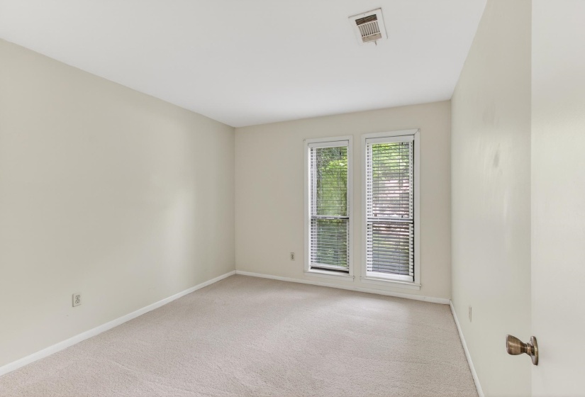 The third bedroom features views of the north lawn and a walk-in closet!