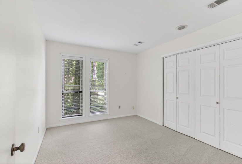 The fourth bedroom also offers views of the north side landscape, and offers two double closets!