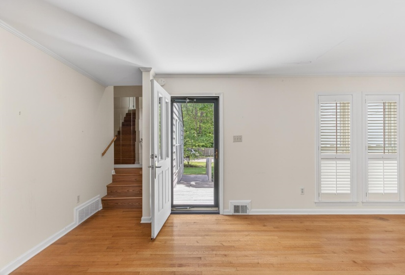 The front entrance welcomes you into the formal dining room and other entertainment spaces of the home.  The primary suite is to the left and the staircase leads up to the loft and guest bedrooms.