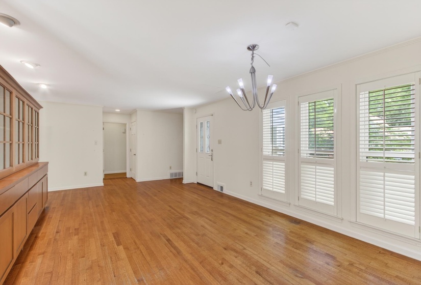 The morning sun shines into this most spacious dining room with it's wall of windows, and golden hardwoods.