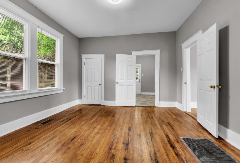Neutral gray walls complement the rich wood-finish flooring