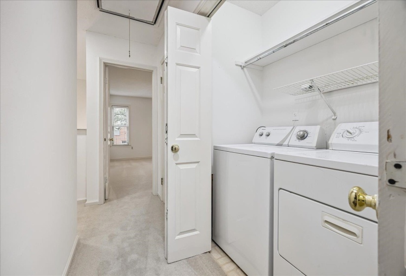 Dedicated laundry area featuring a white top-load washing machine and front-load dryer