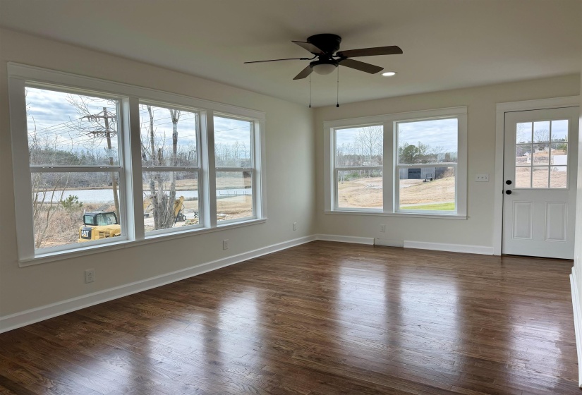 Interior space featuring dark wood finished floors, healthy amount of natural light, a ceiling fan, and recessed lighting